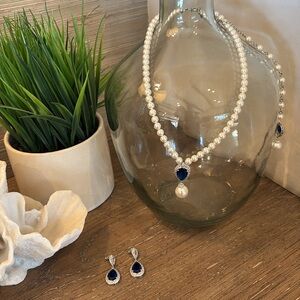 Adjustable pearl necklace & matching pierced earrings. Sapphire color gem.